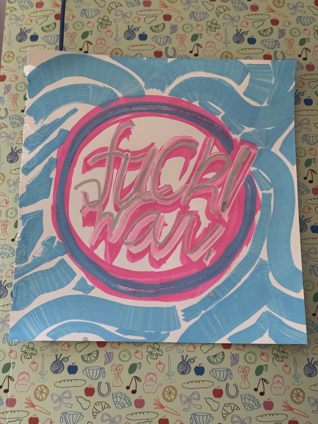 fuck! war. in pink script on a white disc with pink and blue rings, on a blue wash
