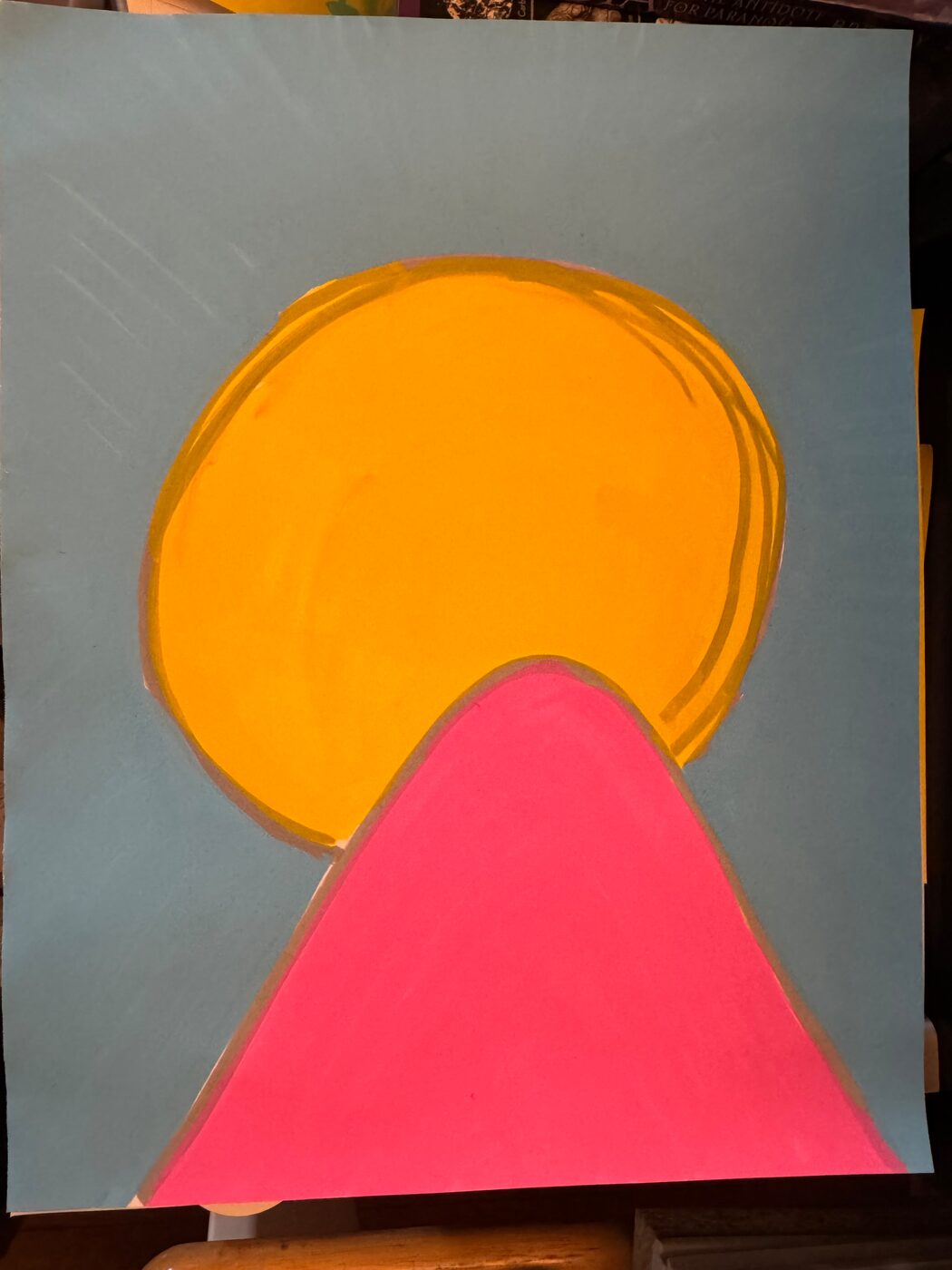 A yellow-orange sun with loose ochre rings behind a pink peak, on a pale blue sheet